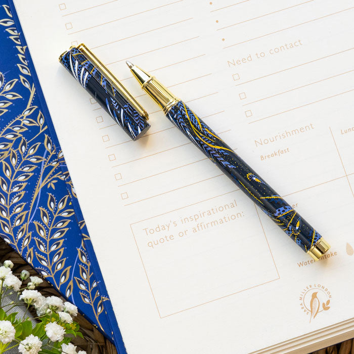 Ballpoint pen presented in box, with peacock feathers design in indigo and gold.