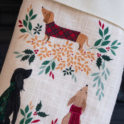 Embroidered fabric with dogs and floral patterns on a beige background