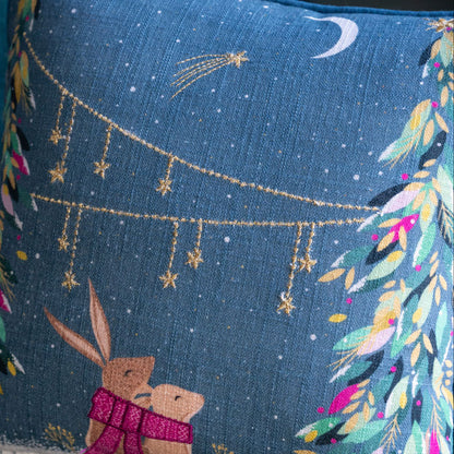Decorative pillow with embroidered design of two animals under a starry sky.