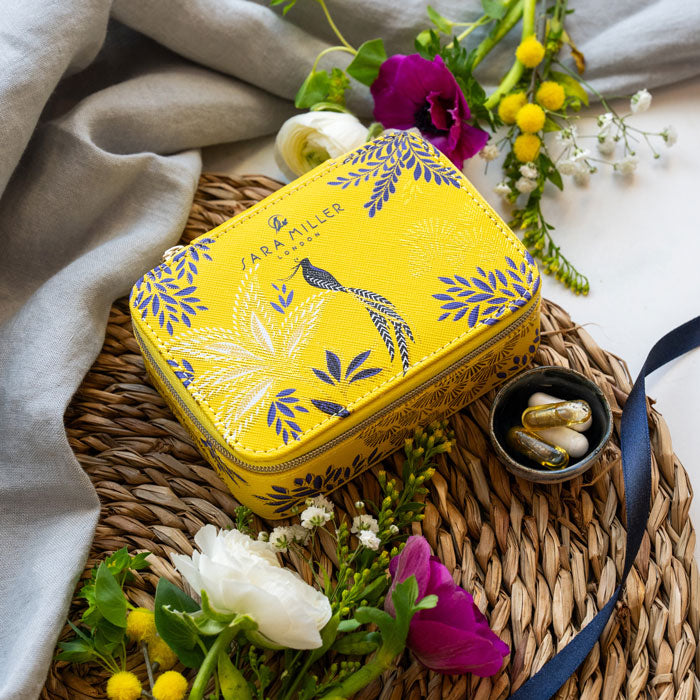 Yellow wellness organiser with botanic and bird design, and gold detailing. 
