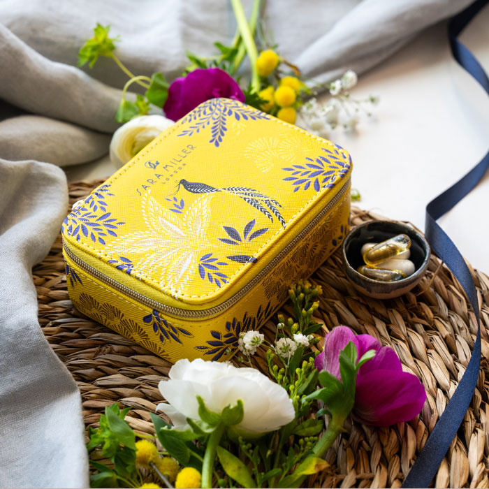 Yellow wellness organiser with botanic and bird design, and gold detailing. 
