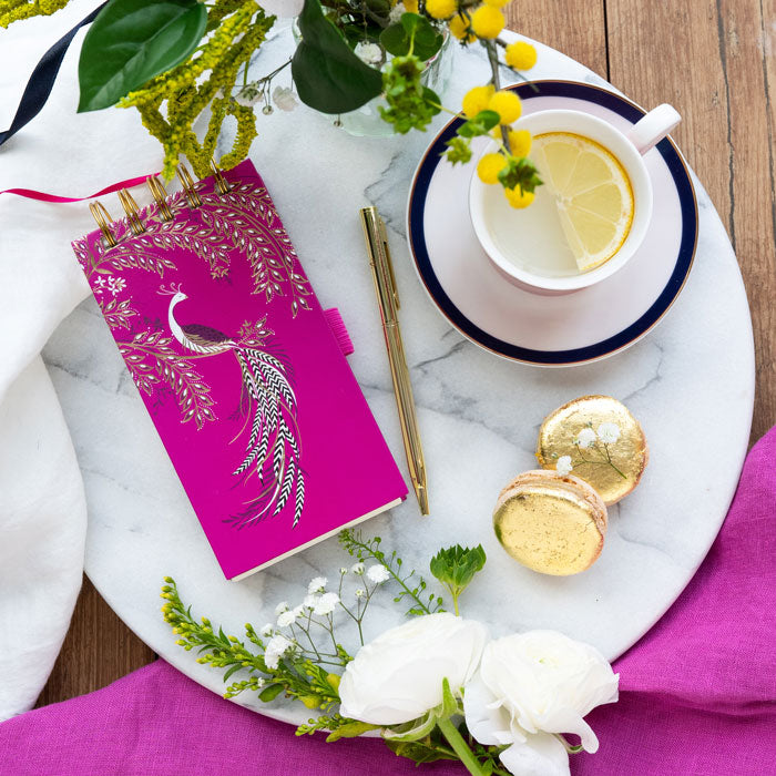 Fuchsia notepad and gold pen set with elegant bird design, gold embellishments.