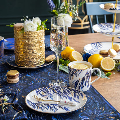 Elegant table setting with floral decorations, a glass of champagne.