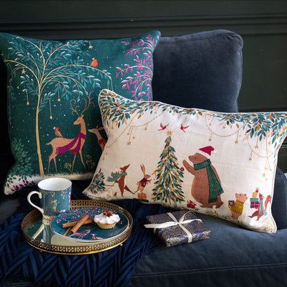 Decorative pillows with festive designs on a couch, including a mug and small gift.