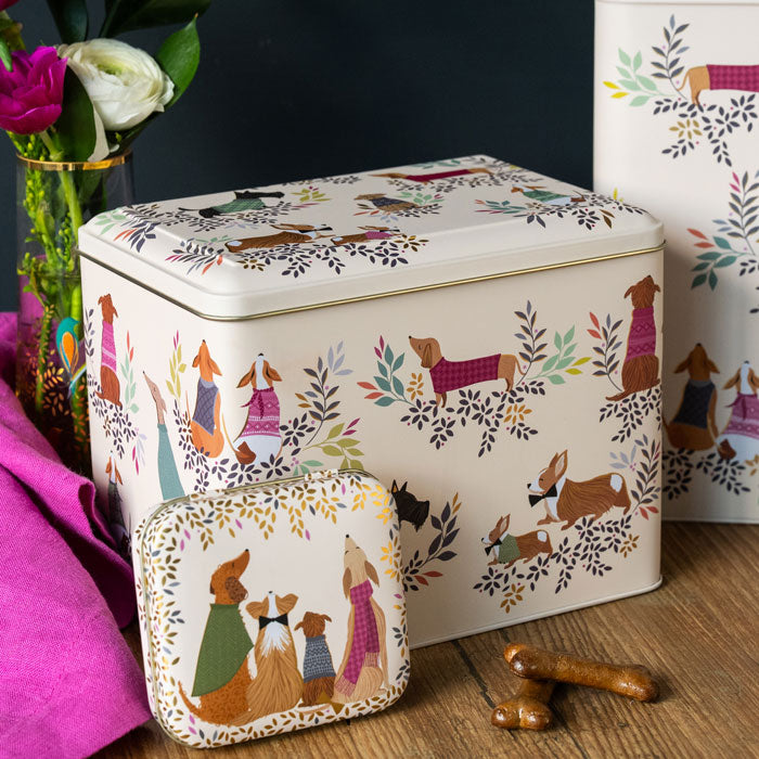 Tin storage container with cute dog design and foliage, light beige base.