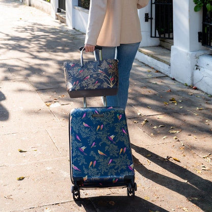 Somebody wheeling the cabin case with the matching handbag.