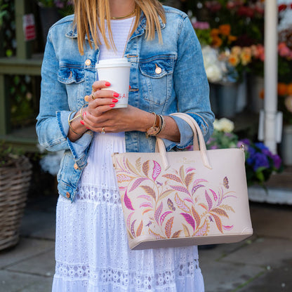 Somebody holding the tote style bag over their arm.