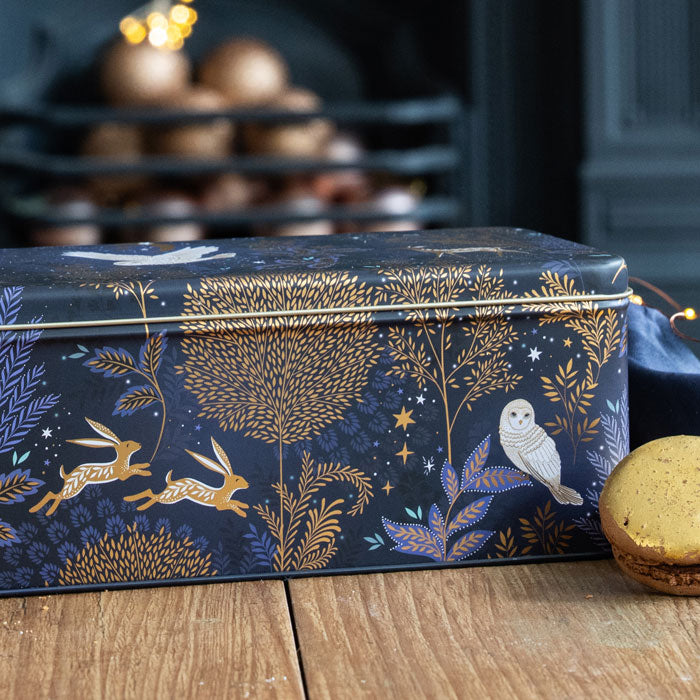 Decorative box with moonlit forest design on a wooden surface
