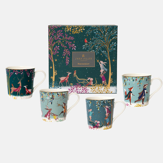 A set of four assorted fine china mugs with whimsical woodland animal designs, including deer, a robin, rabbits, and skaters, with gold embellishments all against different green backgrounds next to matching gift box.